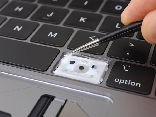 Un primer plano de la nueva membrana de goma añadida a los teclados de los MacBook 2018.